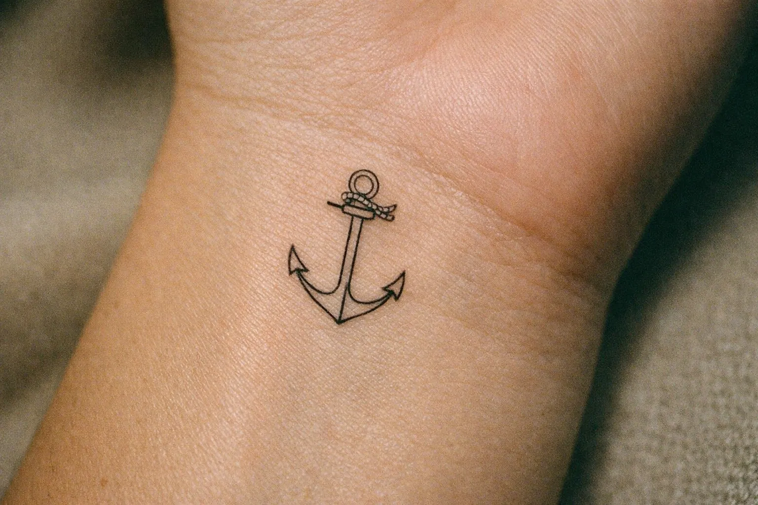 Anchor tattoo intertwined with a rose on forearm, single tattoo