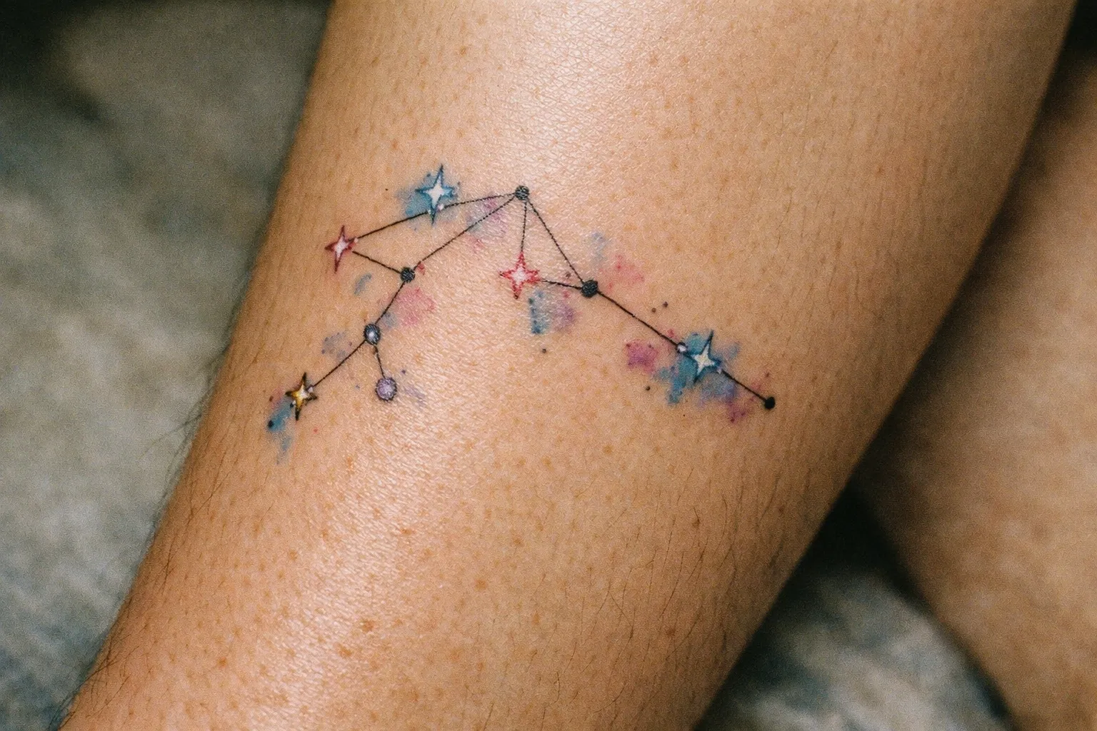 Aquarius constellation tattoo on a person's leg.