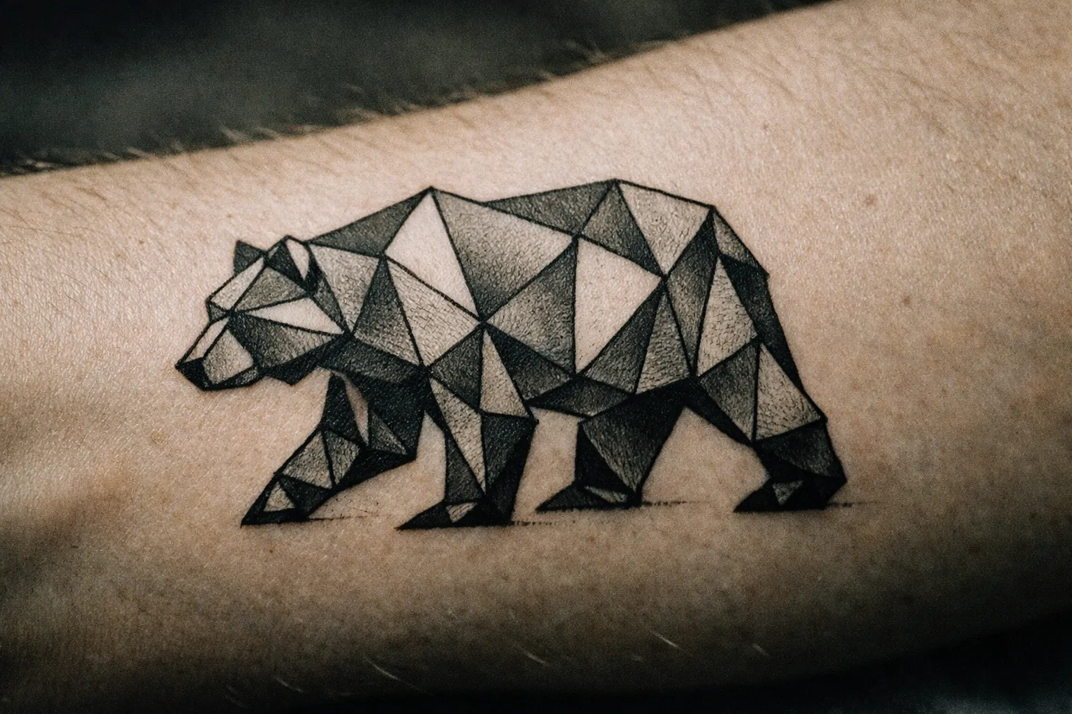 Geometric bear design on forearm with polygon shapes