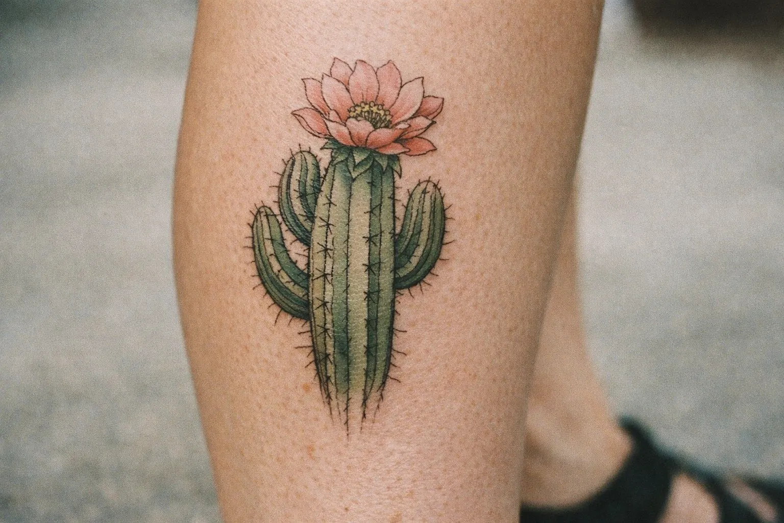 Calf tattoo showing a cactus with blooming flower