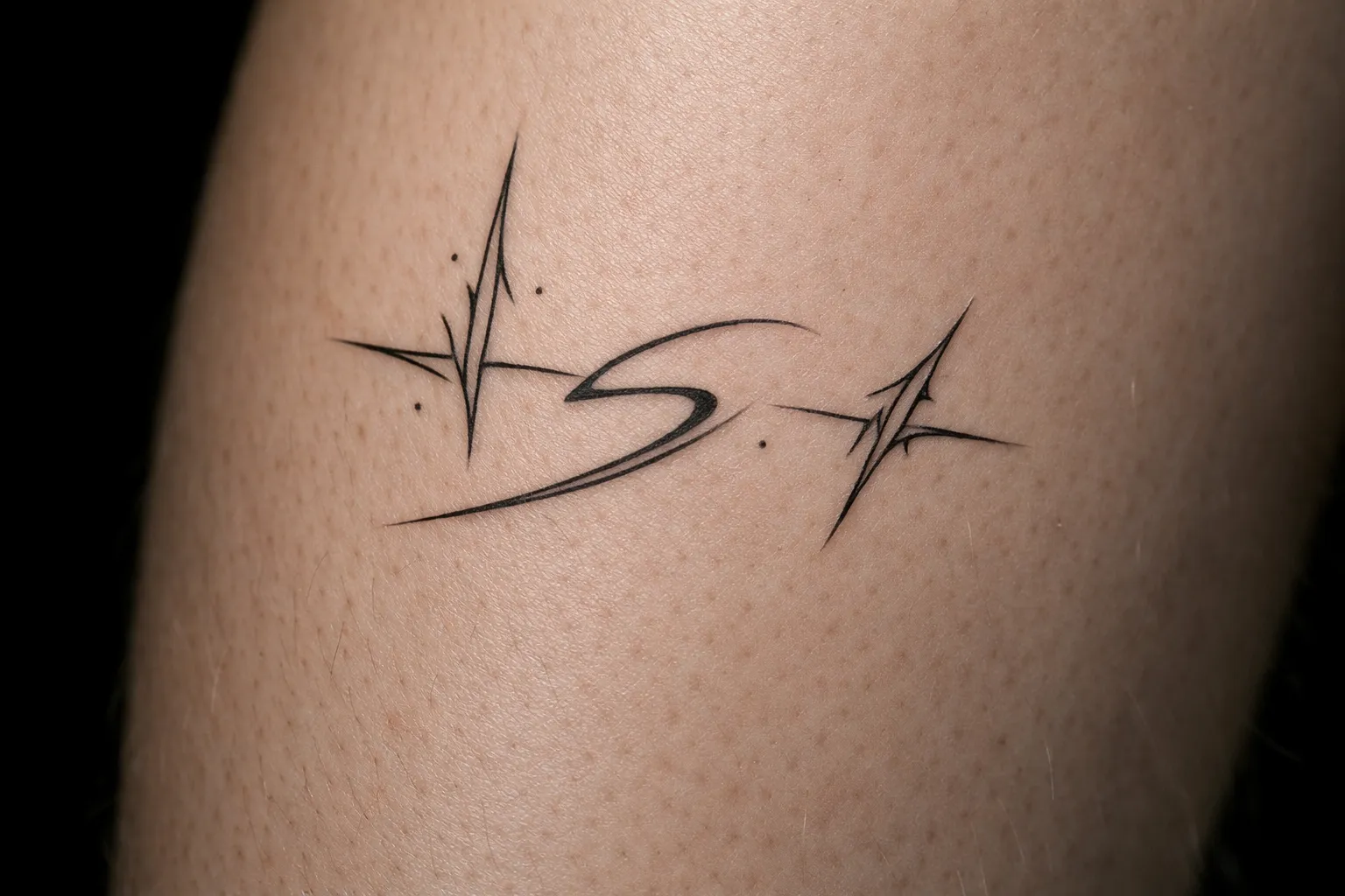 A minimalist black cyber sigilism tattoo on a person's skin.