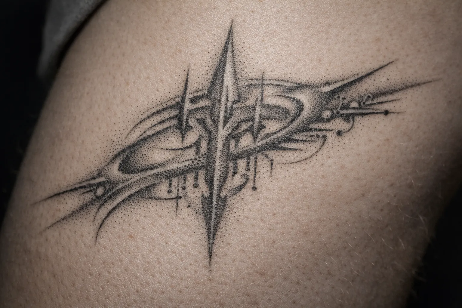 A geometric cyber sigil tattoo is inked on a person's skin.