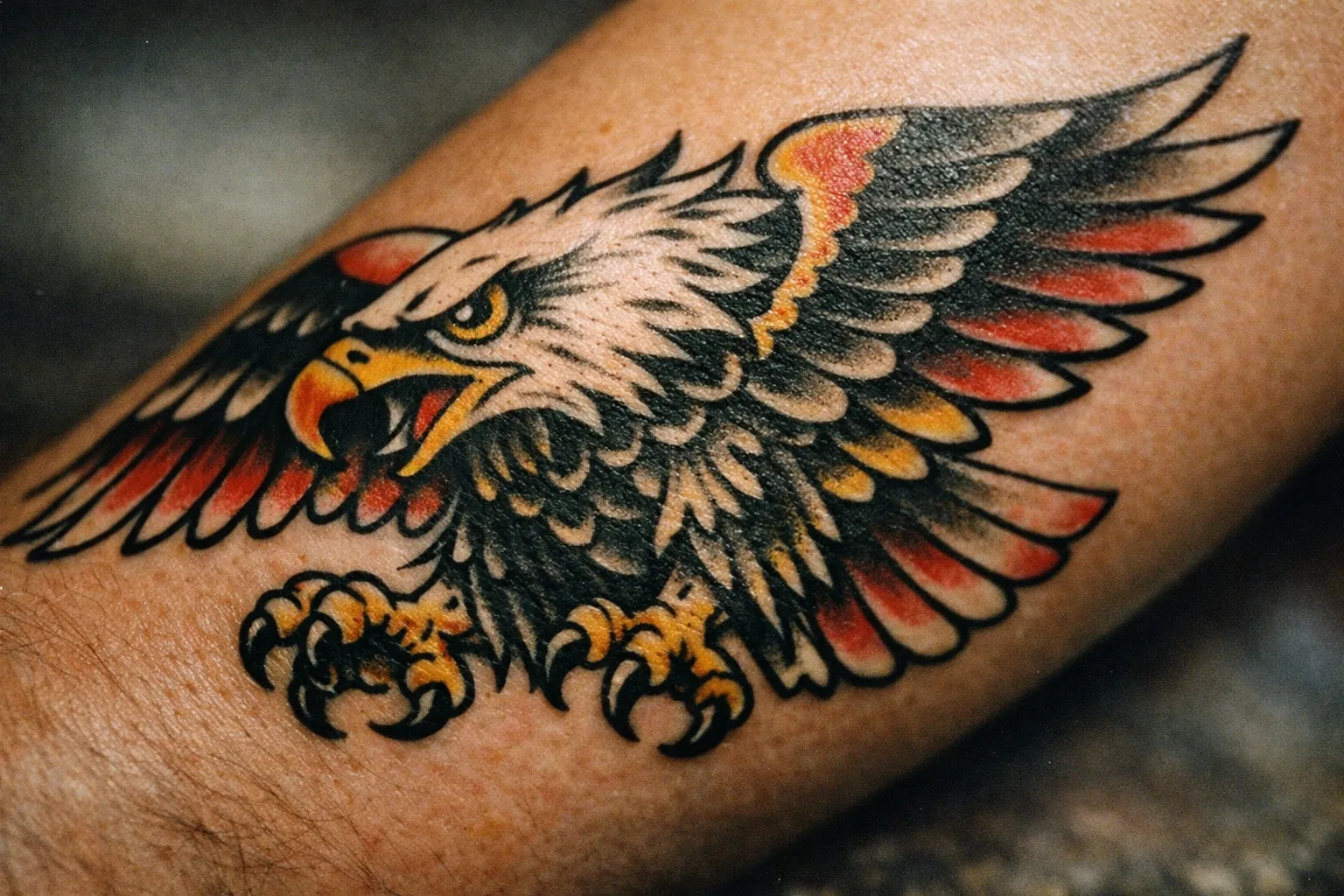 Forearm eagle tattoo symbolizing freedom and strength, bold linework on healed skin