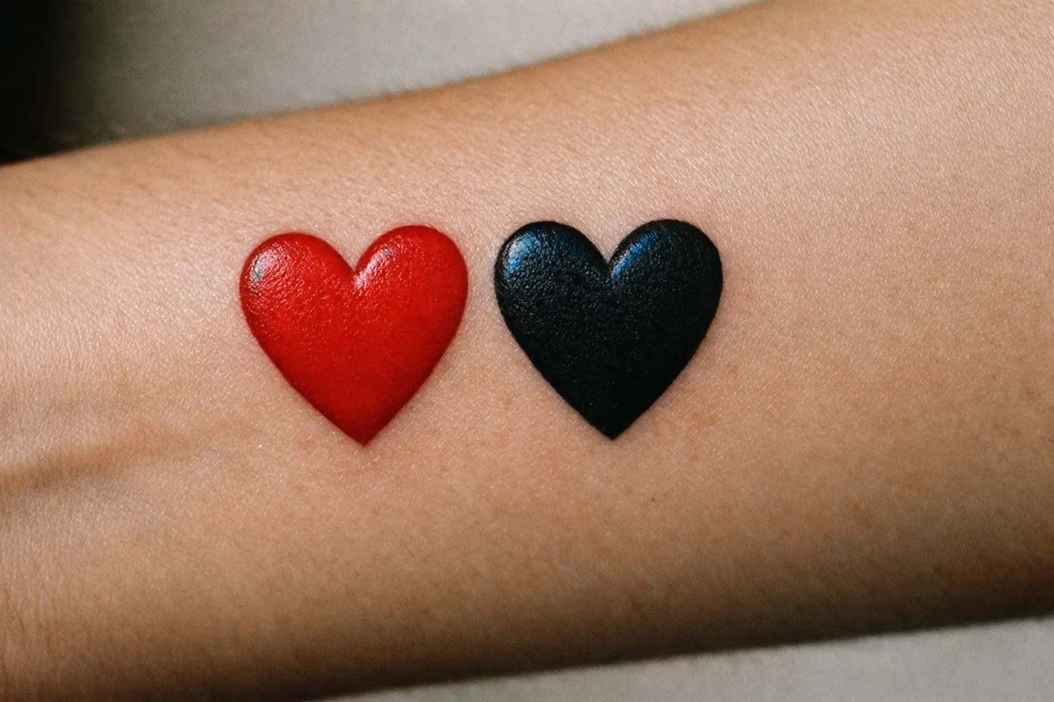 Broken heart tattoo on forearm with cracks and shading, editorial close-up