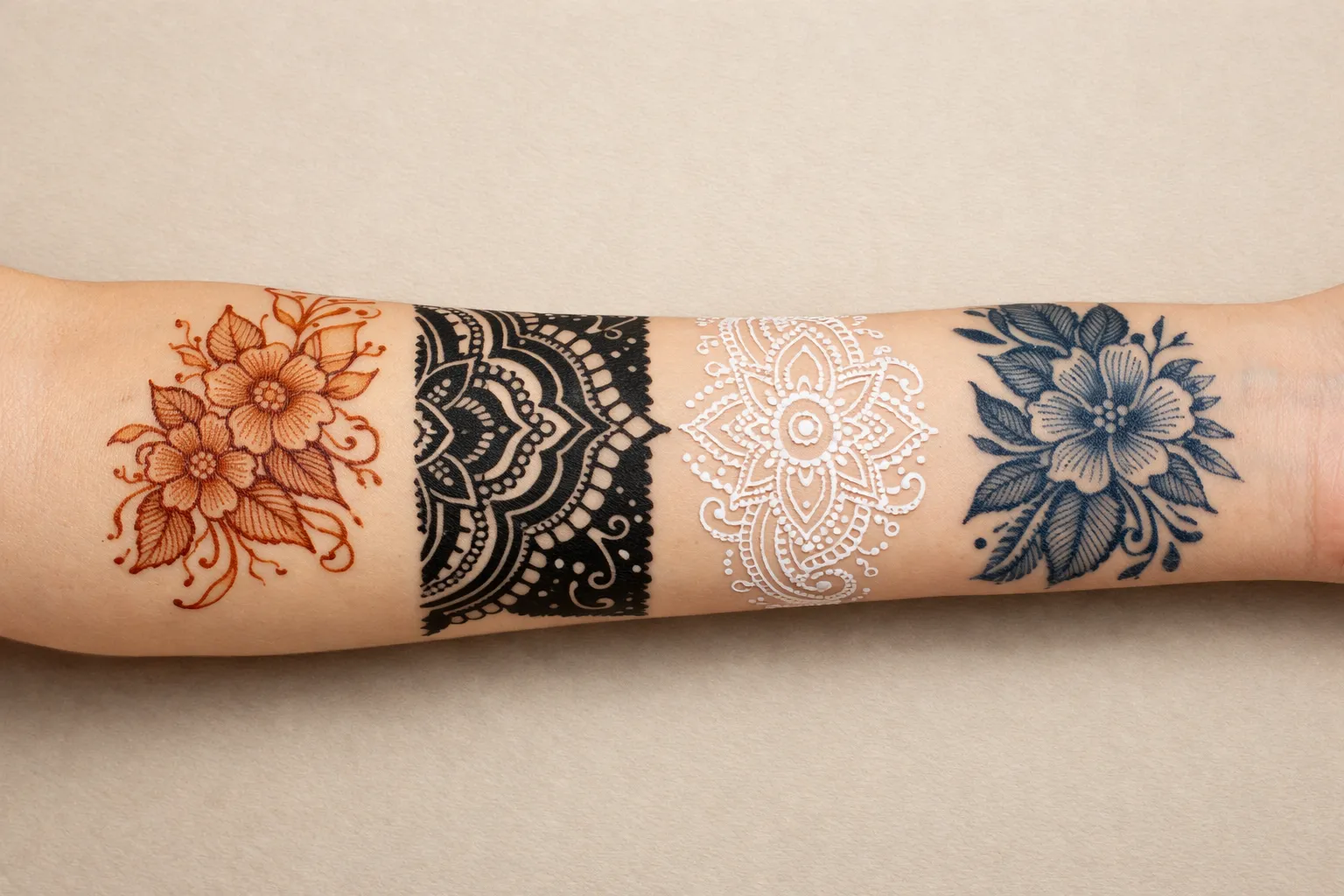 Forearm showing four distinct henna-related mediums as separate zones: natural, black, white, and jagua.