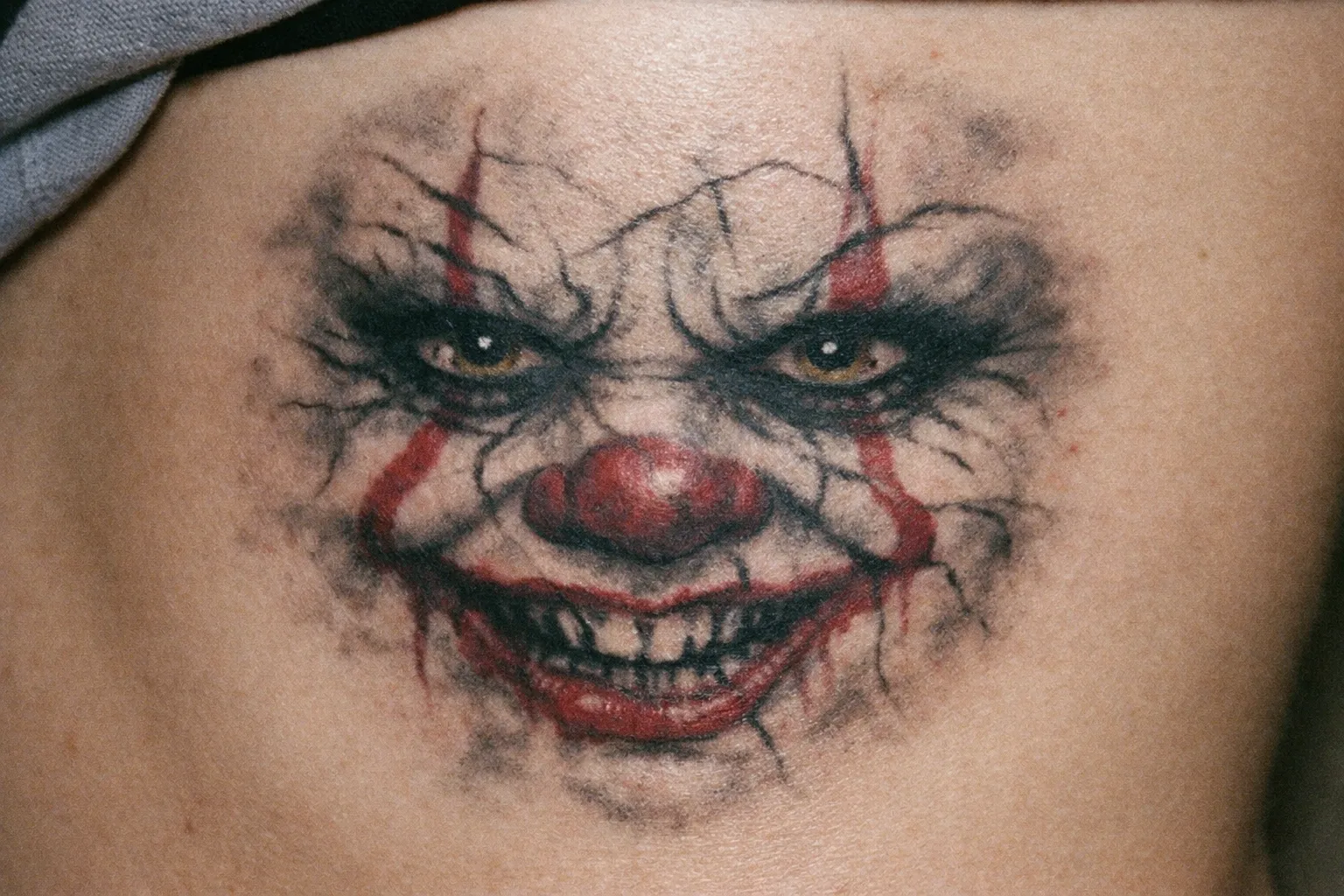 Poor Pennywise ribcage tattoo with messy linework