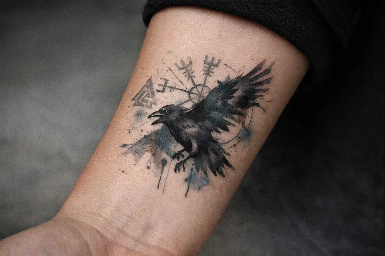 A tattoo of a crow in flight with abstract symbols on a person's inner forearm.