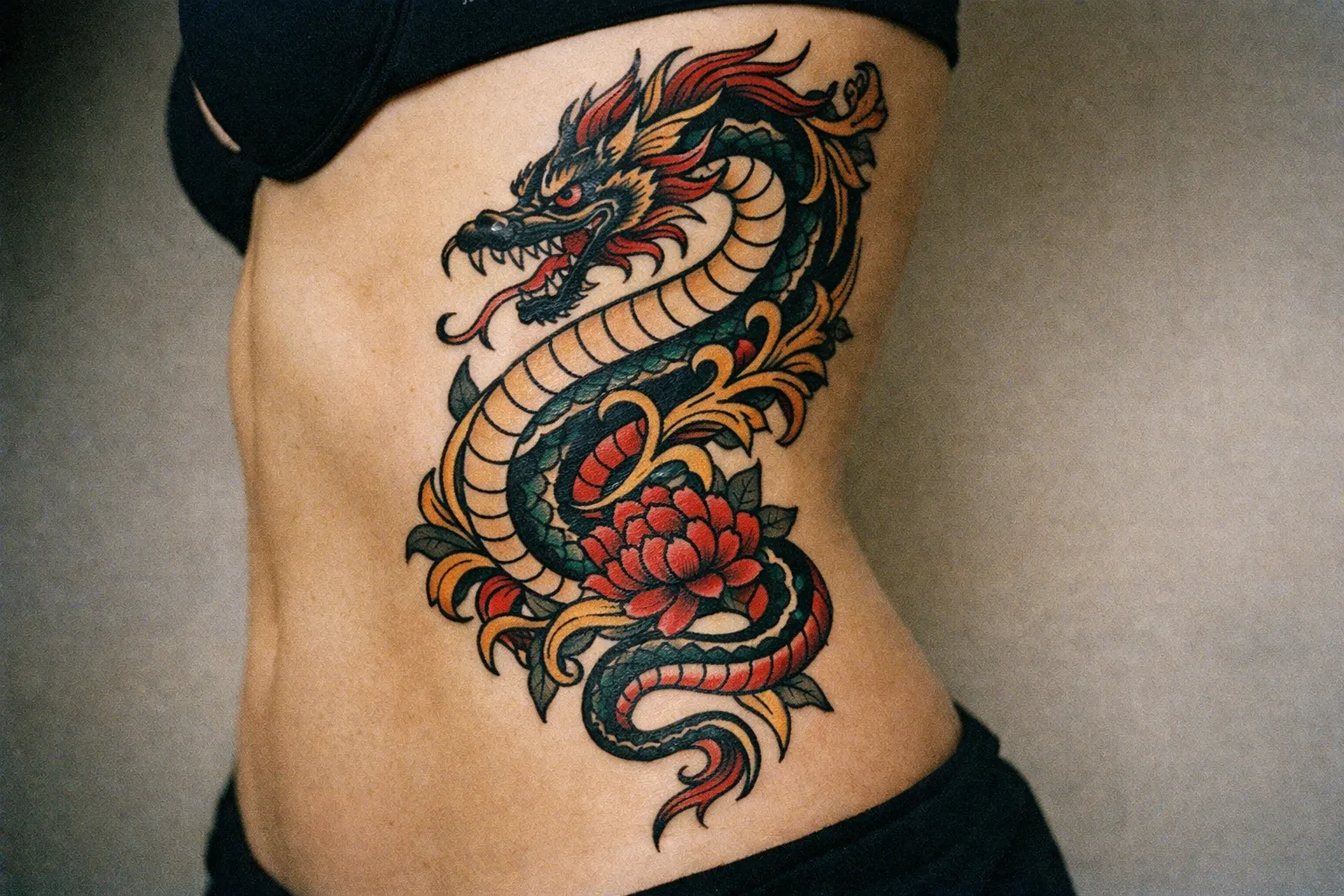 A person with a large colorful dragon tattoo on their ribcage.