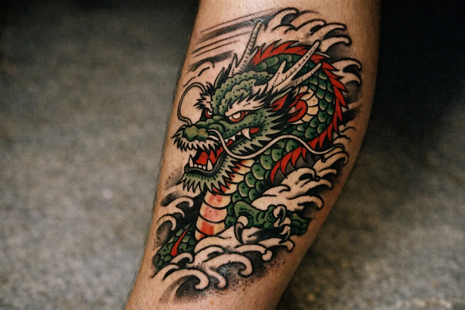A traditional Japanese dragon tattoo is inked on a person's lower leg.
